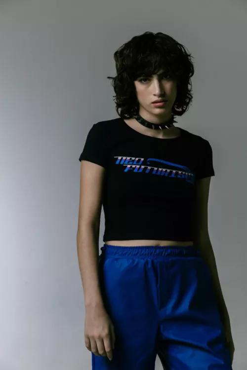 REMERA MANGA CORTA AJUSTADA CON ESTAMPA CENTRAL EN DELANTERO DE ALGODÓN CON LYCRA, LA MODELO ESTA UTILIZANDO EL TALLE S